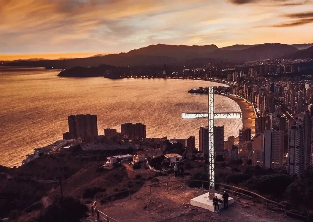 Benidorm Cross illuminated at night.