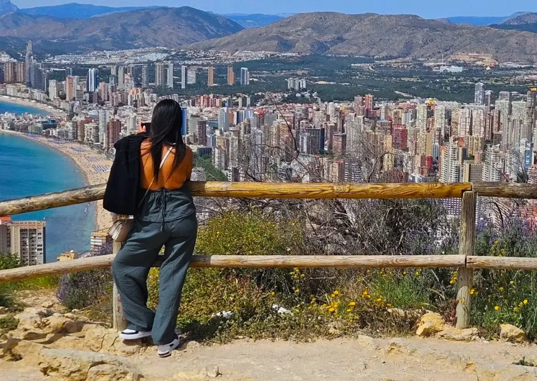 Girl looking down over the resort of Benidorm.