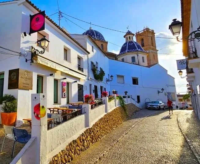 Man walking in street by Altea church.