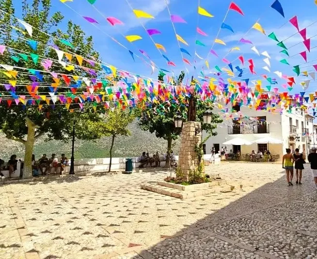 Flags fluttering in a Guadalest square.