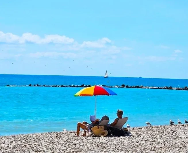 Couple under parasol, La Roda Beach, Altea.